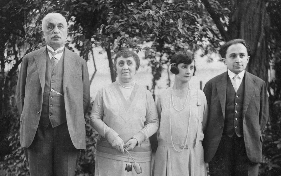 A black and white photo of four people in a garden, from the late 1920s
